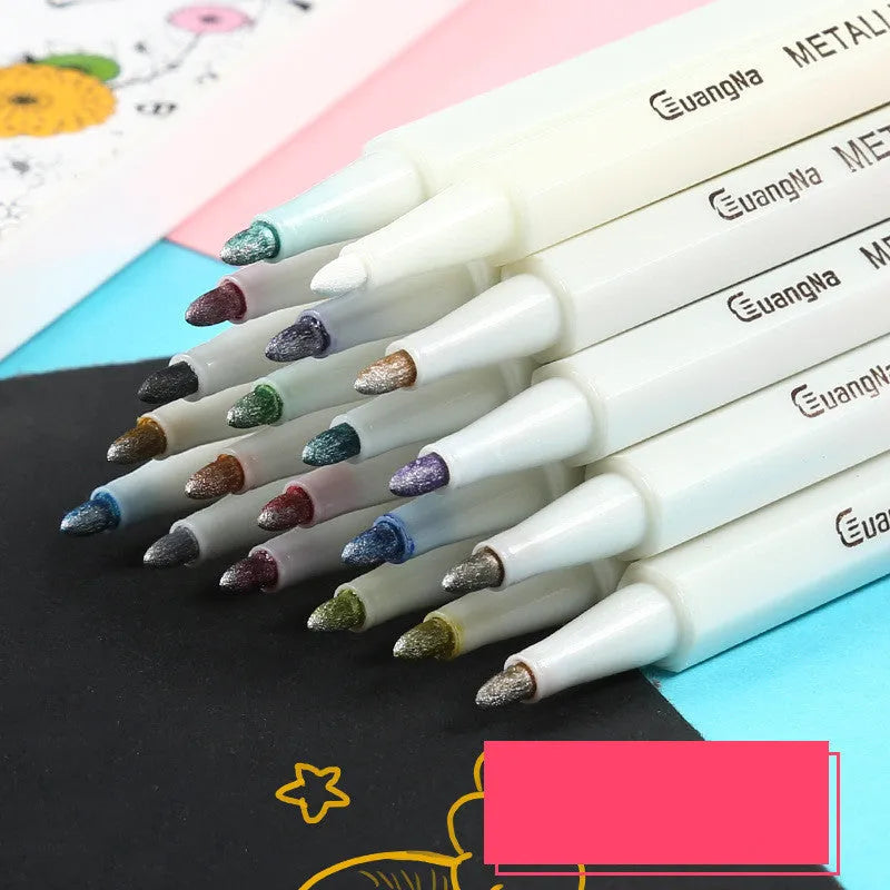 Black card album containing a set of coloured triangular-grip metal pens