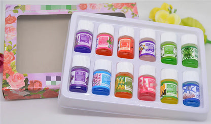 Box of 12 round plastic aromatherapy oil bottles, 25-50mL, featuring lemon, rose, jasmine, lavender floral scents
