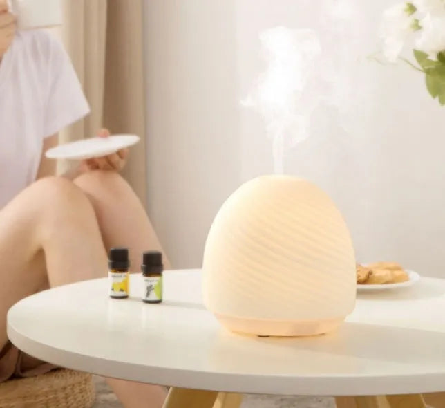 Asakusa threaded glass aroma diffuser in frosted white on a table with a single fog outlet