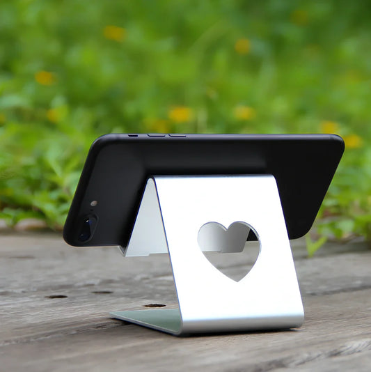 Adjustable black or silvery aluminium stand propping phone and tablet at 20cm height on desk