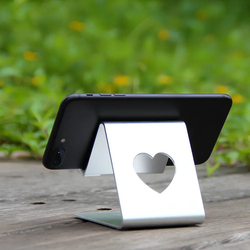 Adjustable black or silvery aluminium stand propping phone and tablet at 20cm height on desk