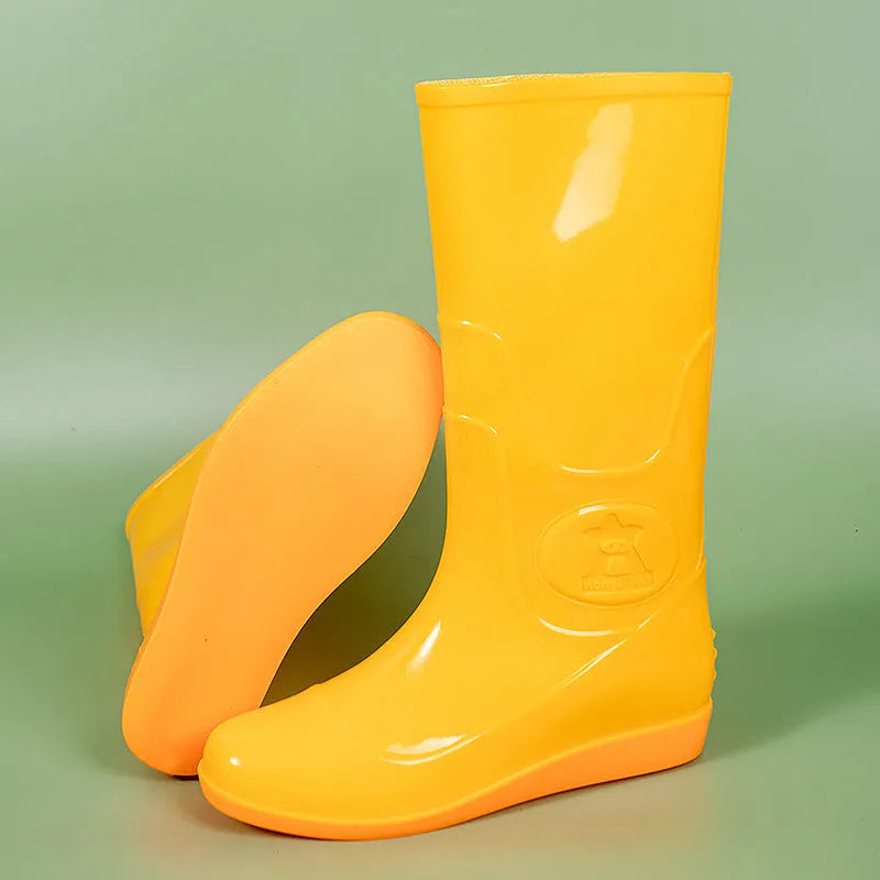 White and yellow high tube plastic rain boots with flat heel and round toe.
