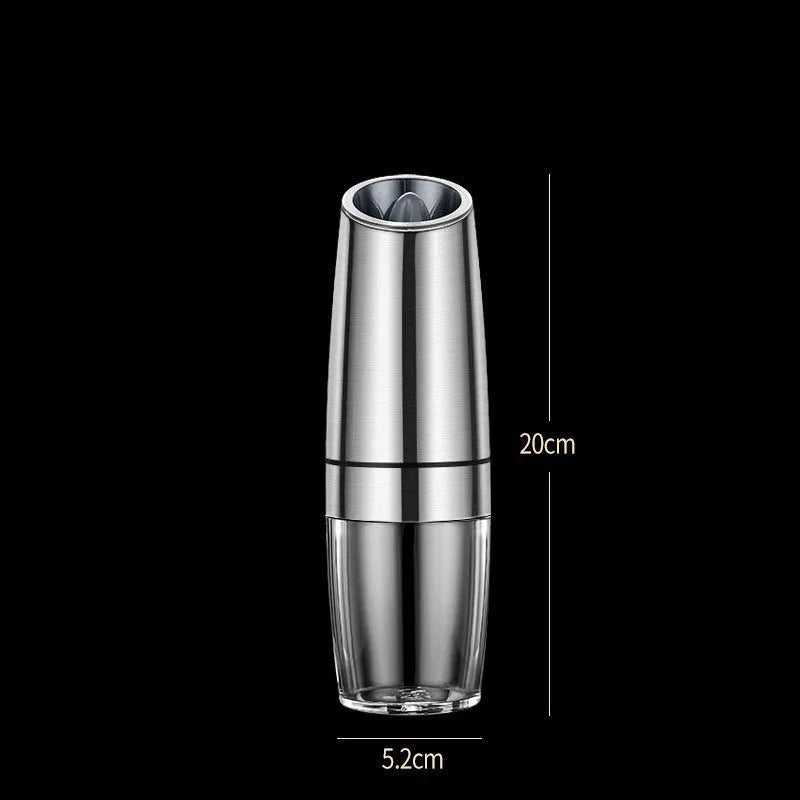 Black and white rechargeable electric pepper and salt grinders with clear acrylic bodies on a kitchen counter.