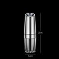 Black and white rechargeable electric pepper and salt grinders with clear acrylic bodies on a kitchen counter.