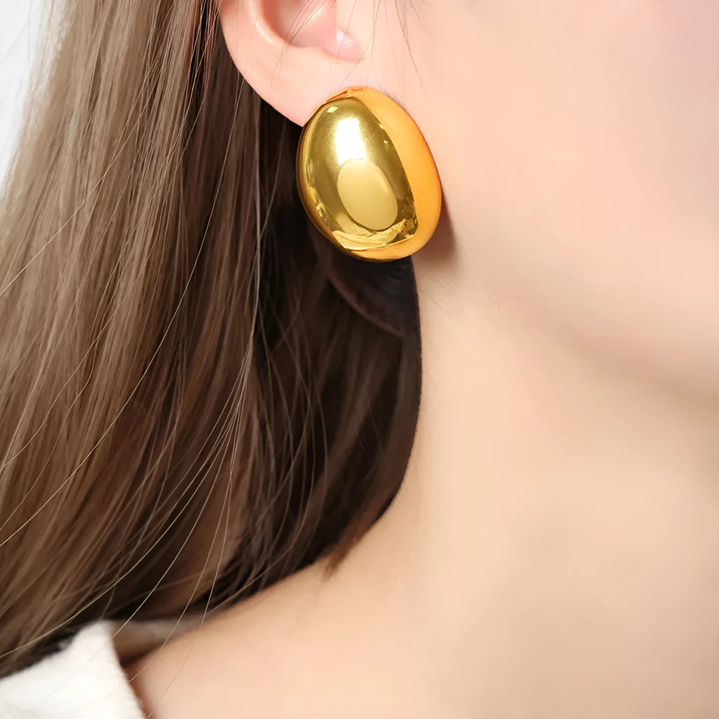 Geometric line design ear studs with stainless steel and 18K plating showing exaggerated glazed surface