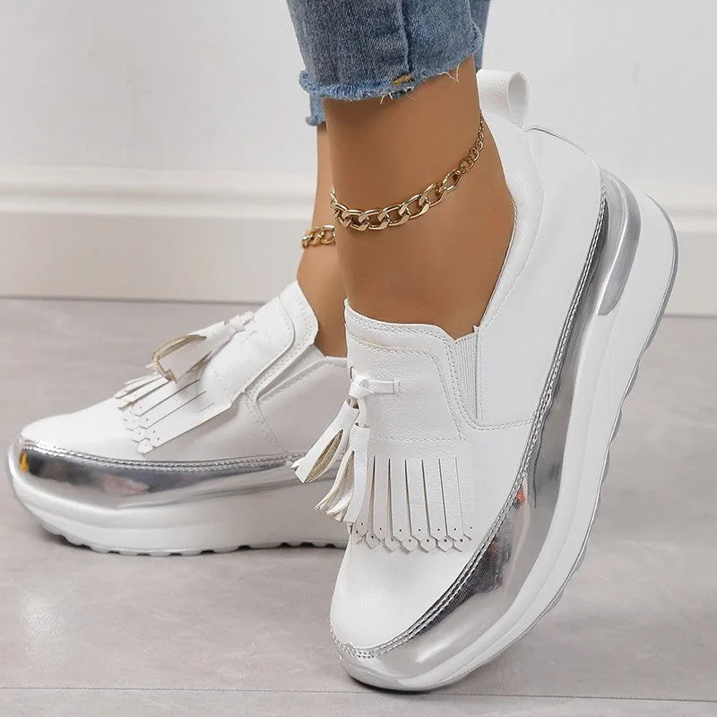 Black women's casual platform shoes with tassel detail and a distinctive English muffin wedge heel.