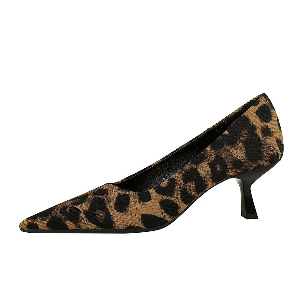 Women's leopard print stiletto high heels with 6-8cm heel and low-top upper on a flat surface
