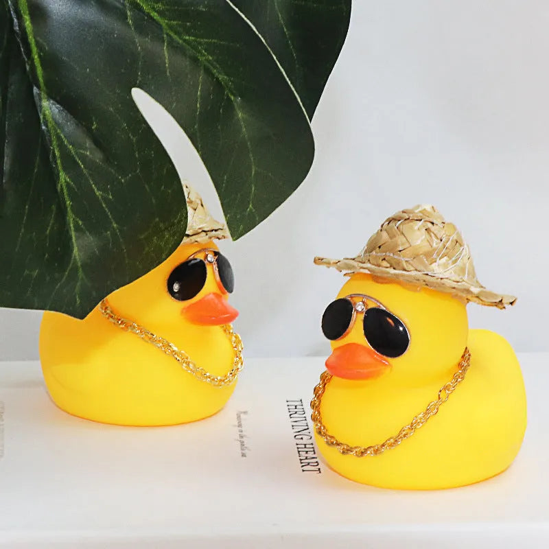 Yellow cartoon duck wearing a straw hat car decoration with adhesive glue and sunglasses accessory.