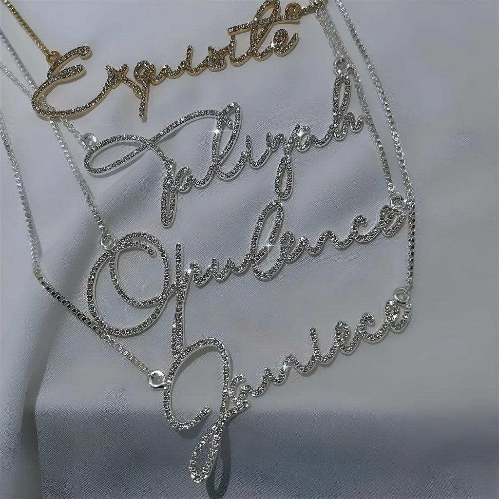 Stainless steel name necklace with diamond-studded letters on a chain, shown in silver, gold, and rose gold finishes.
