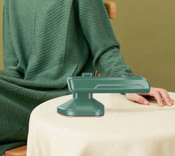 Dark green portable hanging steam iron with ceramic panel and compact design for travel use