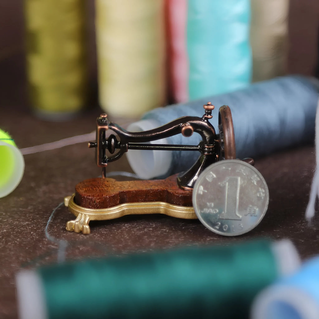 Brown metal simulation mini hand sewing machine dollhouse accessory on display