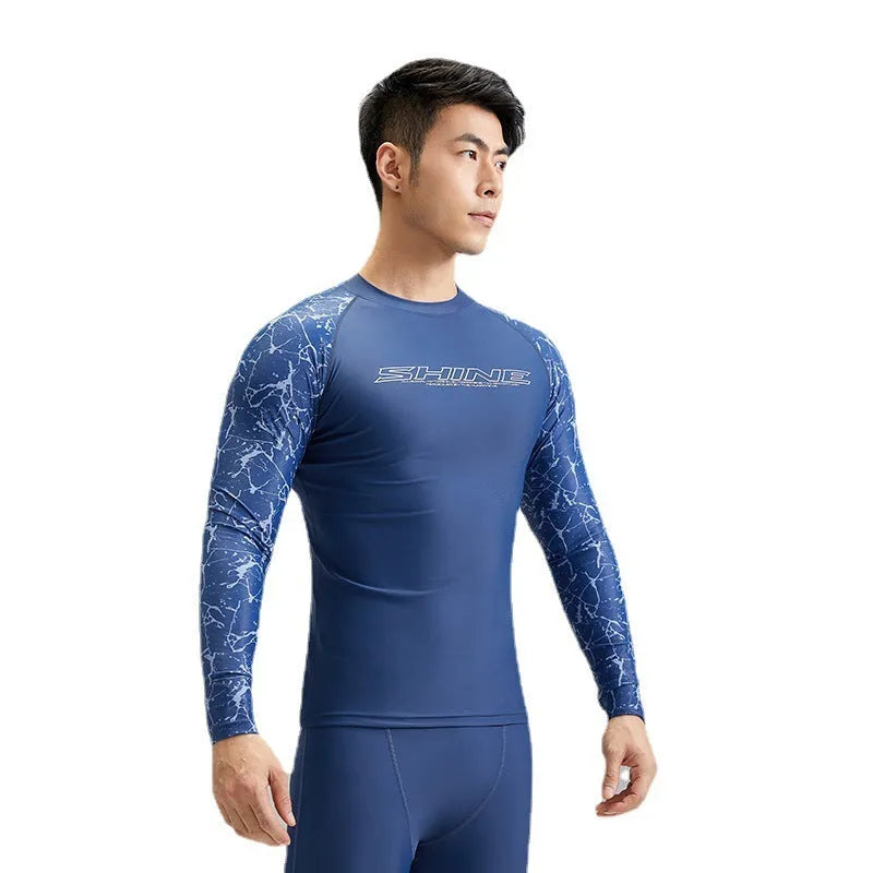 Men's dark blue patterned swim vest and matching swim trunks set on a white background.