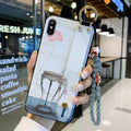 Rose flower decorative wrist strap attached to protective iPhone case compatible with multiple Apple models