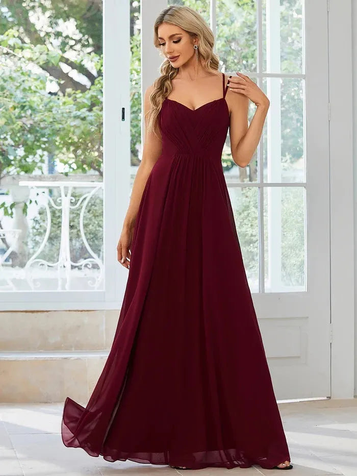 Long pleated A-line dress in light green with sleeveless sling neckline design.