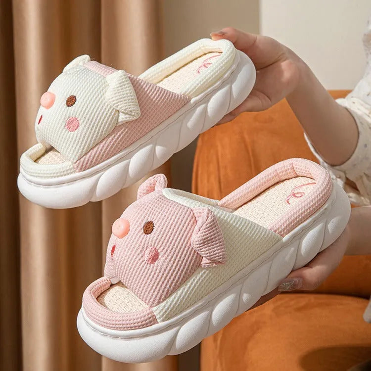A pair of open toe linen slippers for couples on a light background, showing the flip-flop style and linen upper texture.
