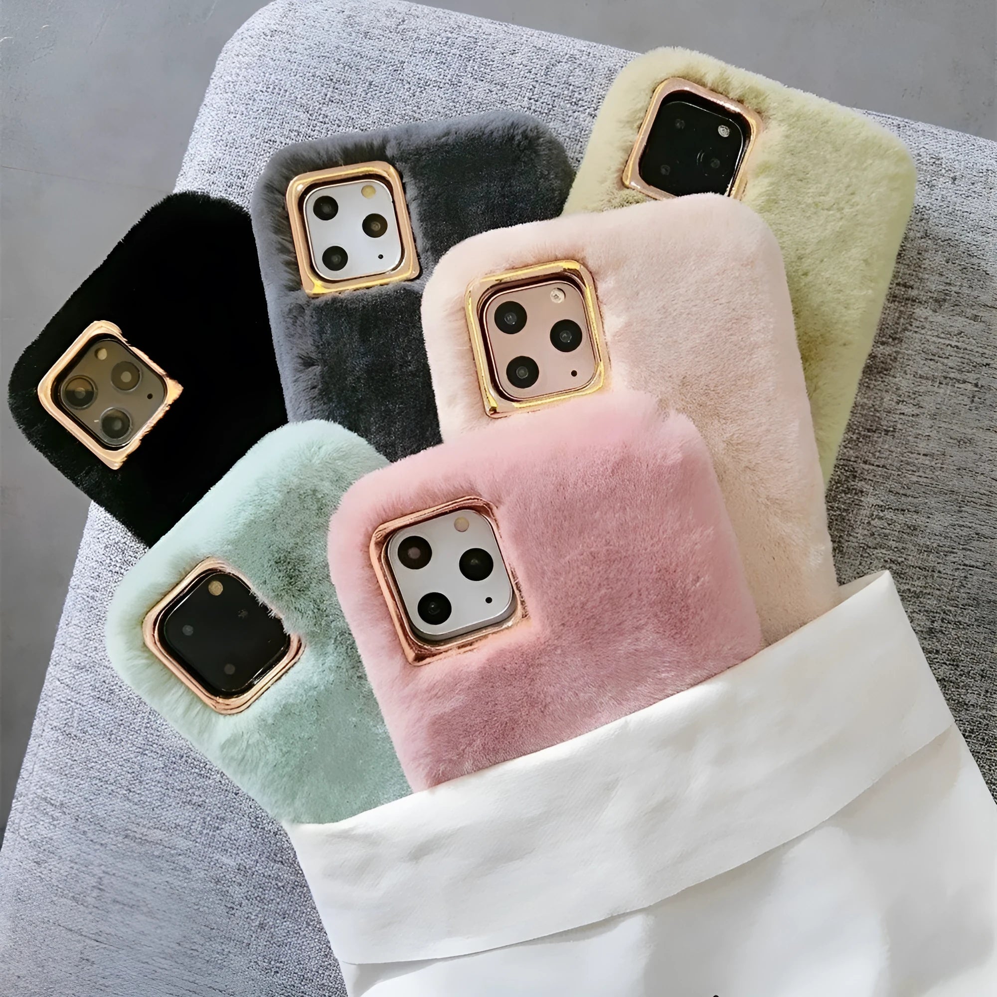 A soft apricot-coloured silicone rabbit plush phone case for an iPhone, showing the raised camera circle and side buttons.