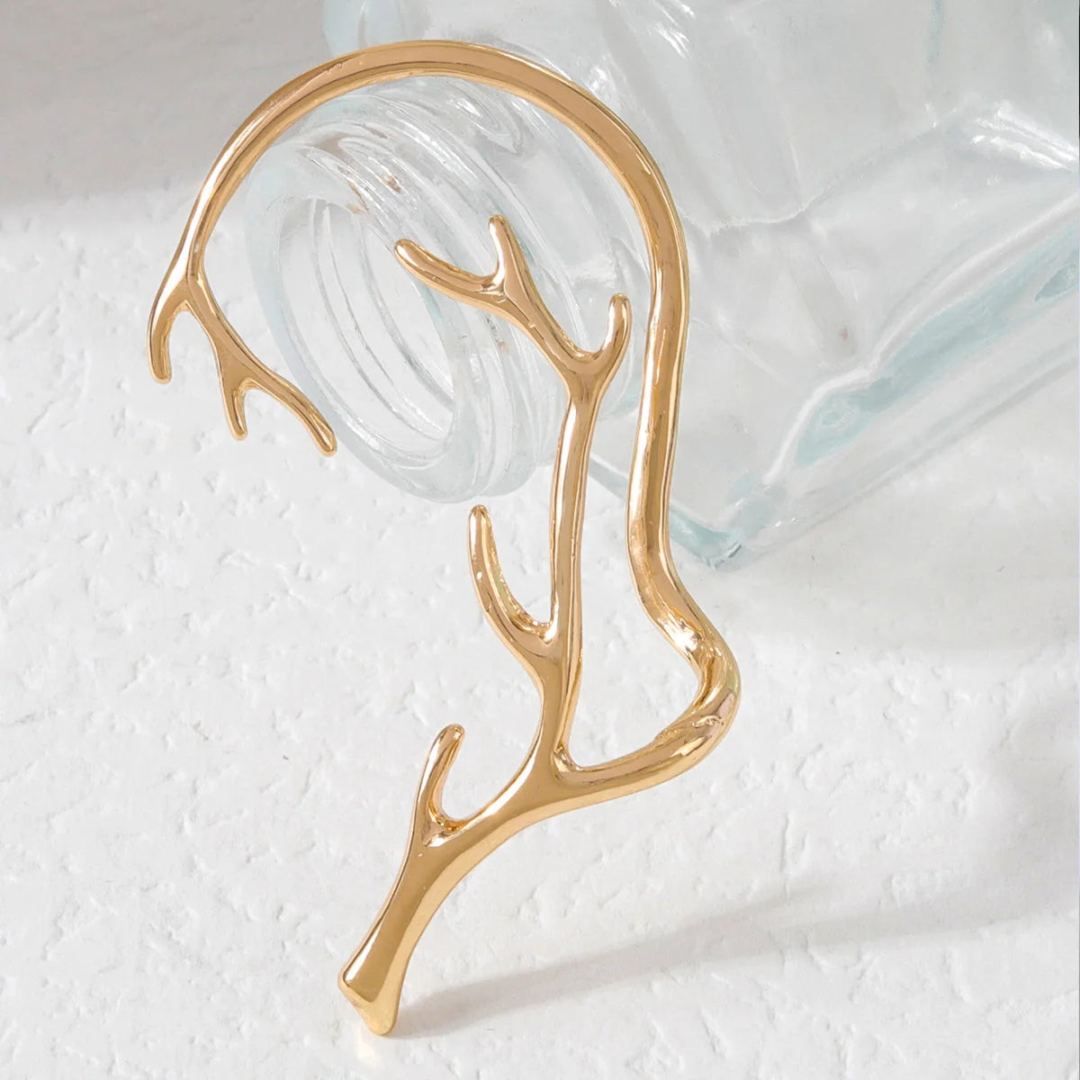 Vintage bone hypoallergenic elf earrings in gold, silver, black, and green with geometric design