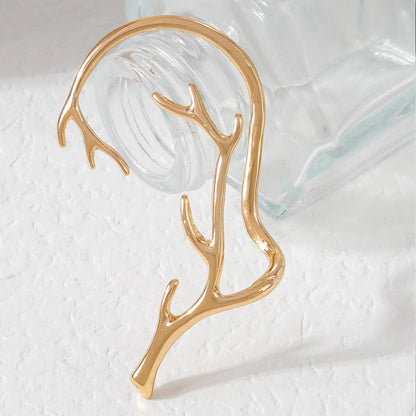 Vintage bone hypoallergenic elf earrings in gold, silver, black, and green with geometric design