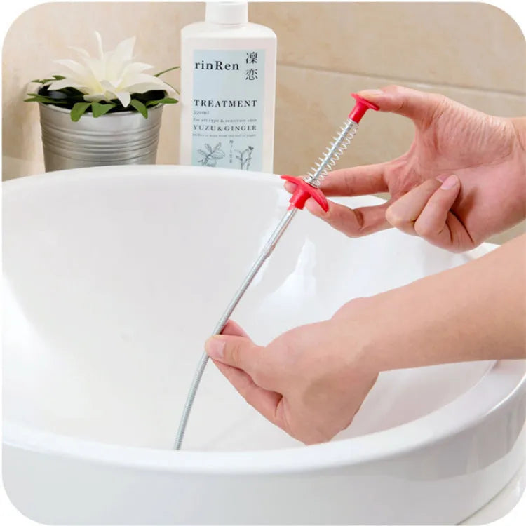 A black sewer dredge spring pipe cleaning tool for unblocking kitchen sink drains