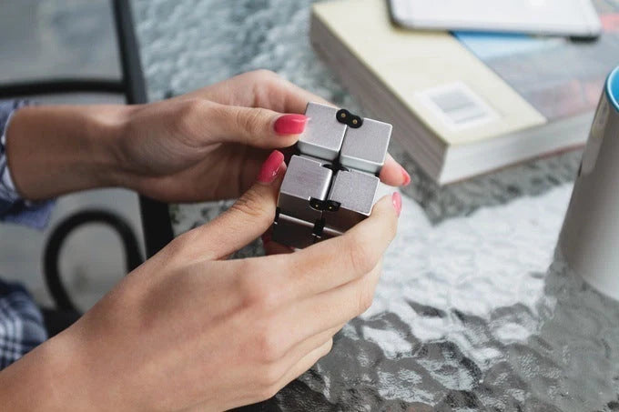 Infinity Cube Educational Toy in zinc alloy, available in multiple colours for focus enhancement and stress relief.