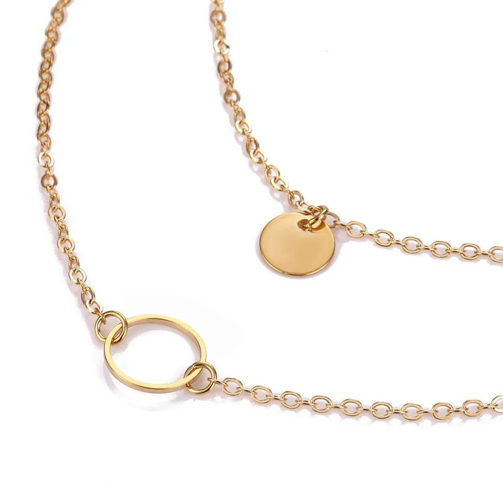 Gold multi-layer sequined choker necklace with drop pendant on woman's neck