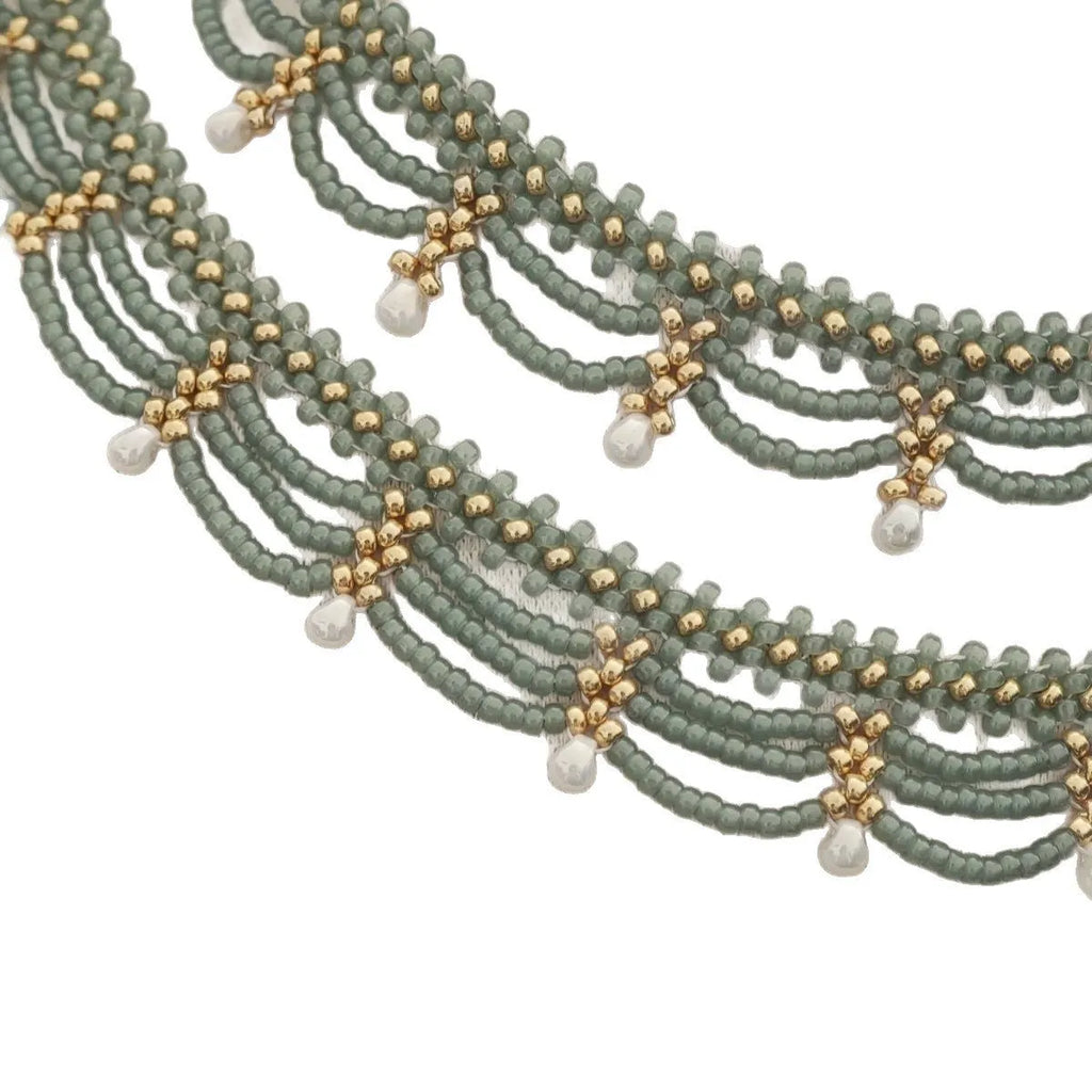 Retro style tassel water drop imitation pearl pendant necklace on display