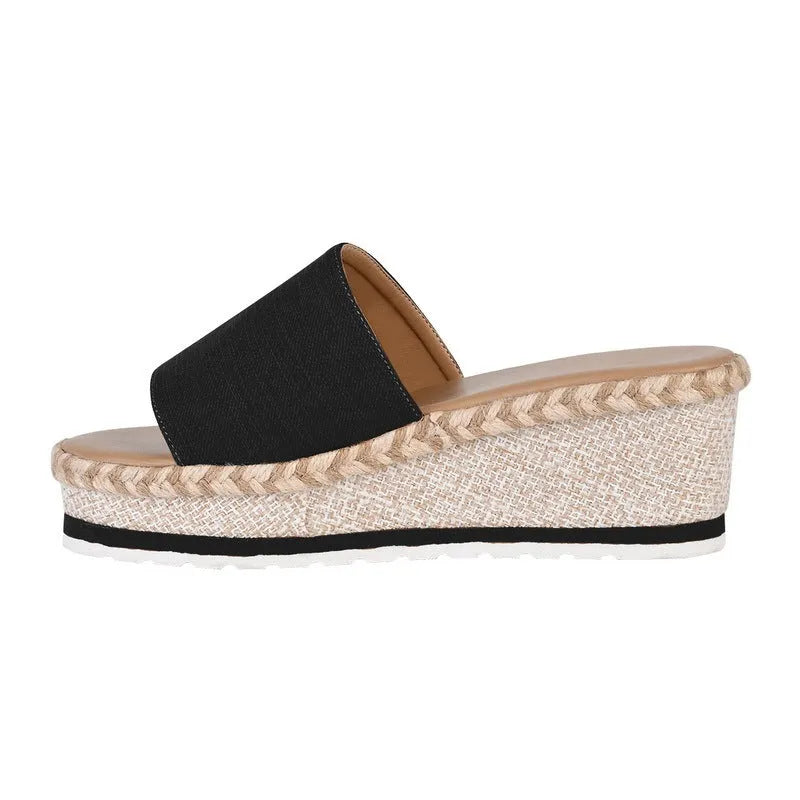 Platform wedge heel sandals with cloth upper in black, side view showing plain pattern and metal element detail