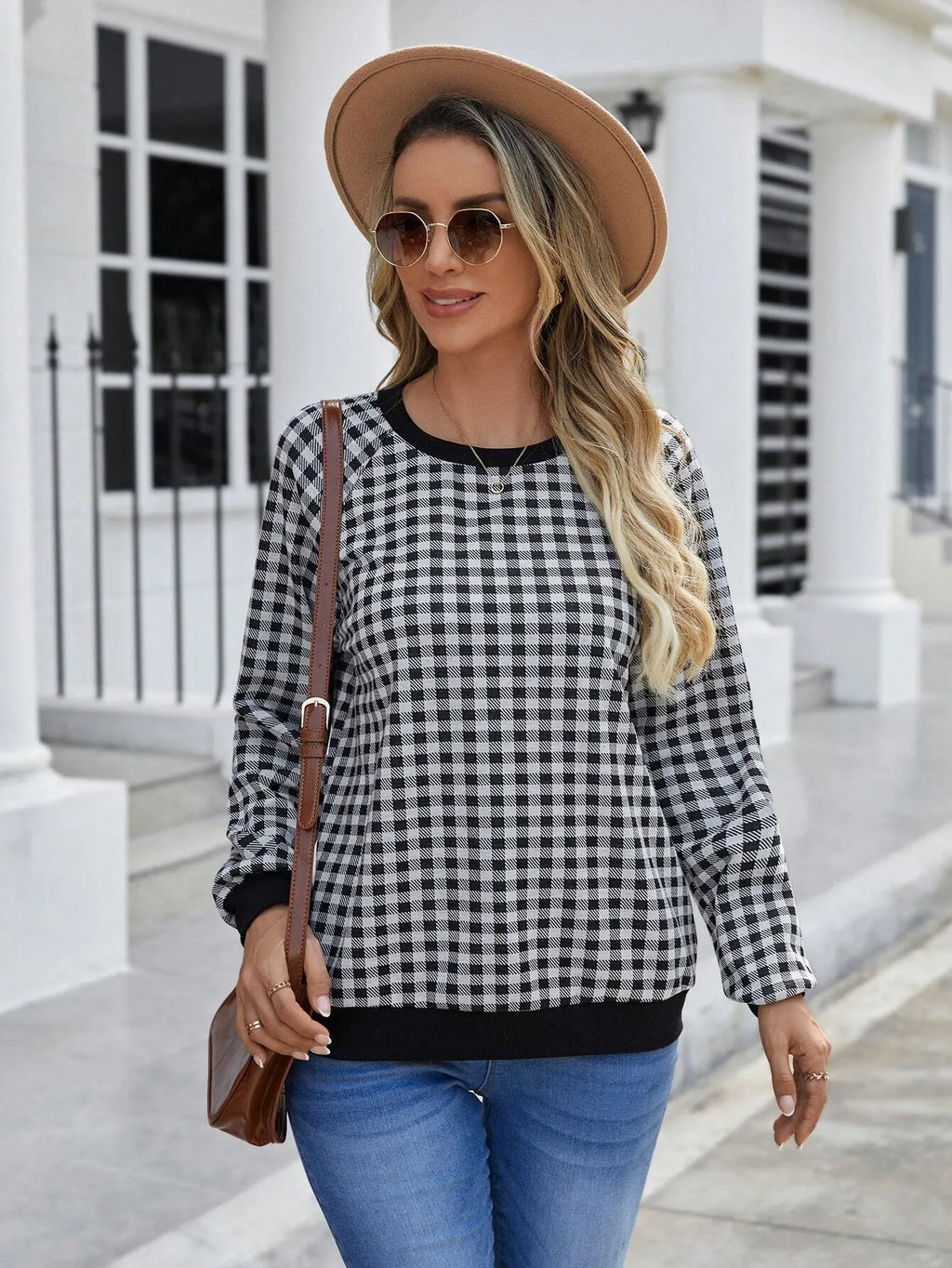 Black long sleeve pullover sweater with a printed plaid stripe pattern on a mannequin.