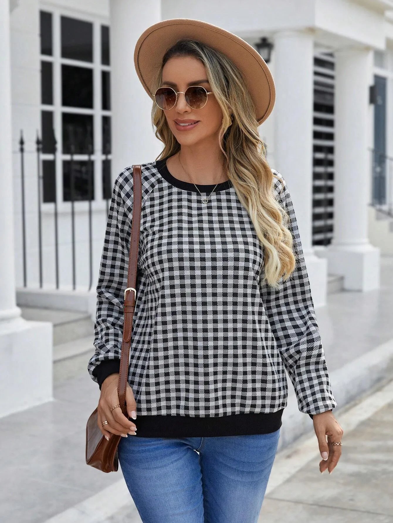 Black long sleeve pullover sweater with a printed plaid stripe pattern on a mannequin.