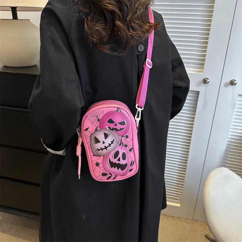 Halloween-themed crossbody phone bag with cartoon pumpkin, ghost, and bat print.