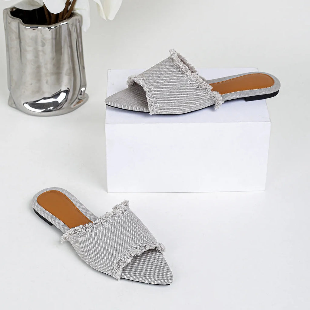 Women's flat denim slippers with a tassel decoration in apricot colour.