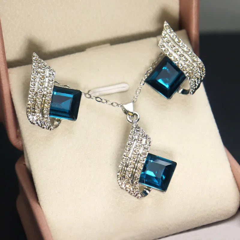 Women's alloy pendant necklace and matching stud earrings set with cross chain and glass accents