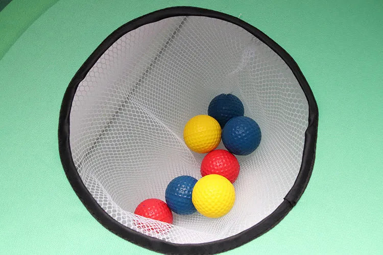 Green golf swing practice net with PVC frame and Oxford cloth target set up outdoors with balls and mat