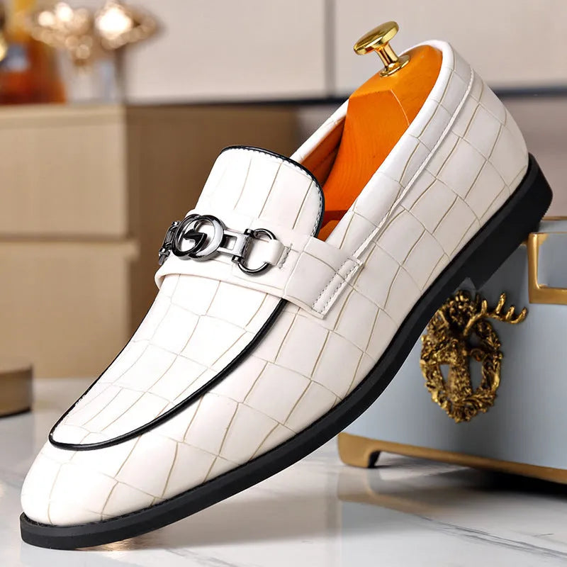 Men's casual leather shoes with embossed horsebit buckle in black, side view showing flat wedge heel and rubber sole