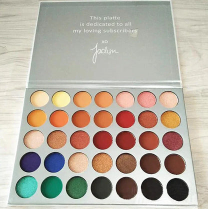 39-colour earth tone eyeshadow palette showing pearlescent and matte finishes in compact with mirror