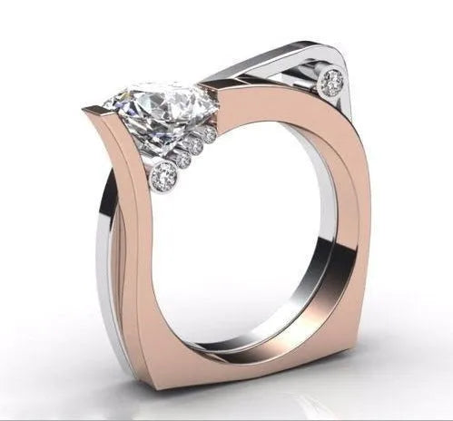 Rose gold geometric alloy ring with a cubic zirconia stone, shown on a finger.