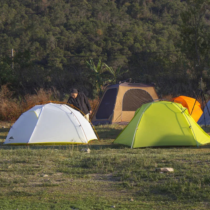 Double layer camping tent in dark green camouflage with two rooms and one hall, aluminium alloy poles, set up outdoors