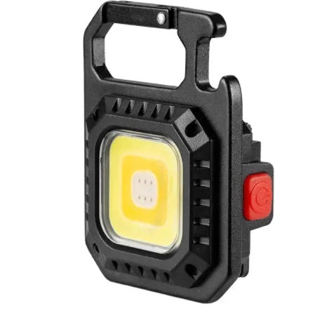 Black multifunctional portable LED torch with aluminium alloy body, magnet base, and control button on a wooden surface