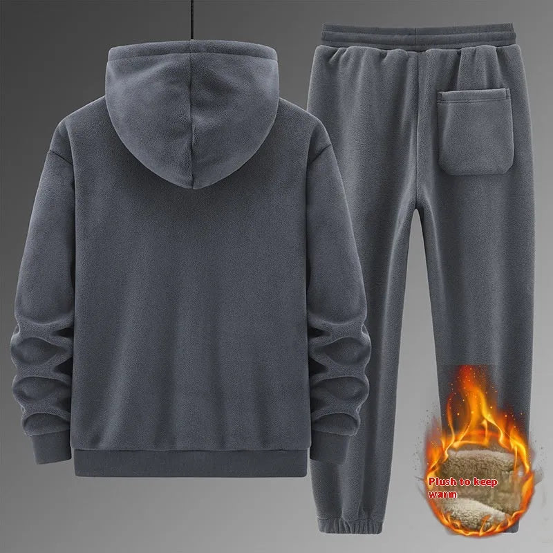 Man wearing a grey hooded cashmere sweater and matching cotton trousers from a casual sports suit set.