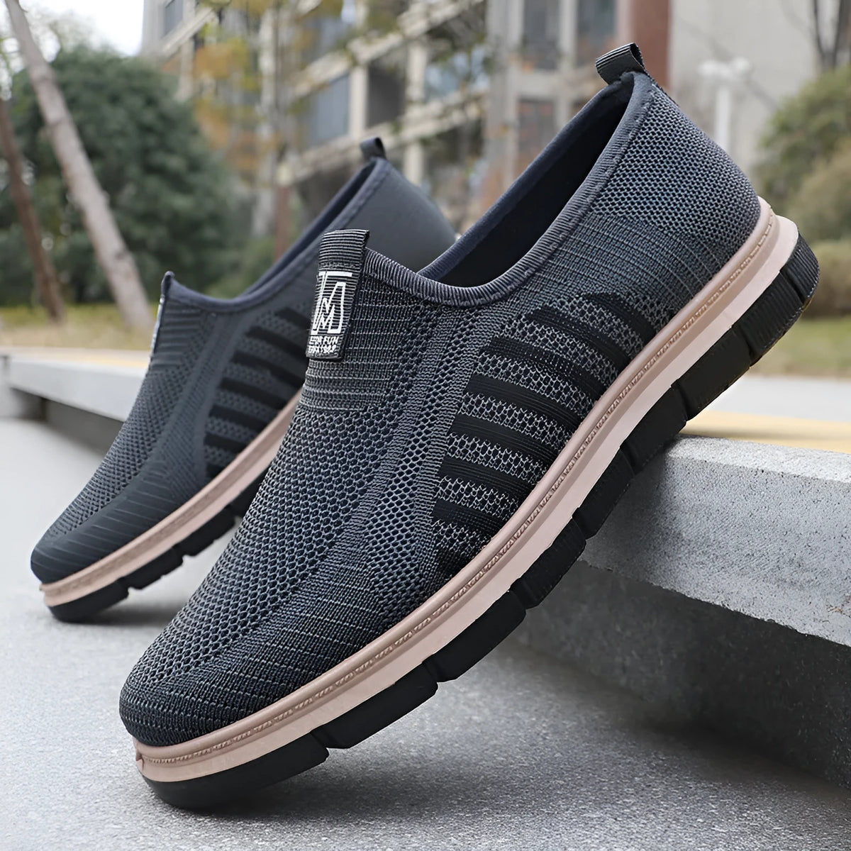 Slip-on soft bottom casual sneakers for men in black with mesh upper and low-top design