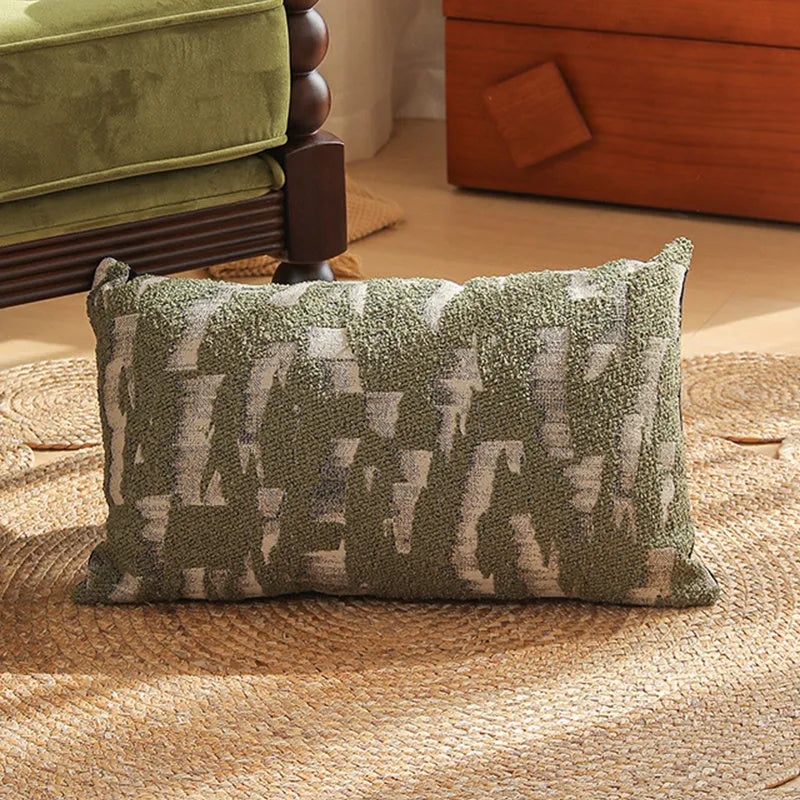 Square jacquard cushion cover with a detailed woven botanical pattern in a retro colour, shown on a grey sofa.