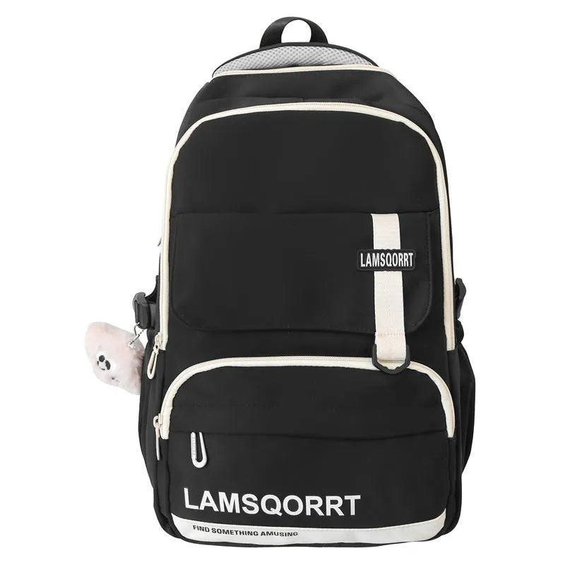 Large black nylon school backpack with curved straps, shown with and without a decorative pendant.
