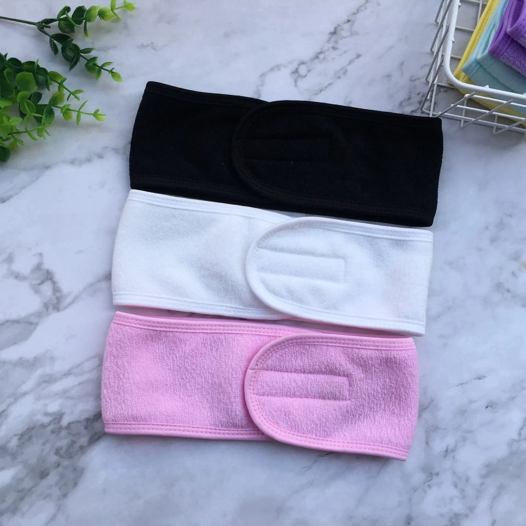 Thickened ant fabric beauty headband in white, pink, blue, purple, yellow on soft surface