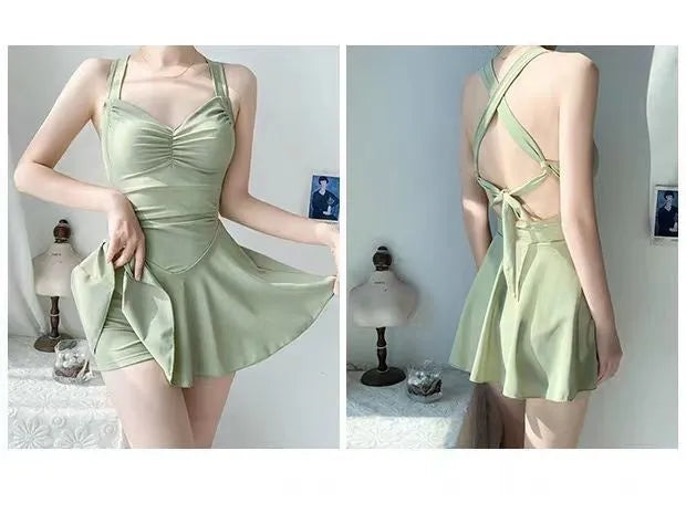 Women's one-piece boxer swimsuit in avocado green, backless design, on a white background.