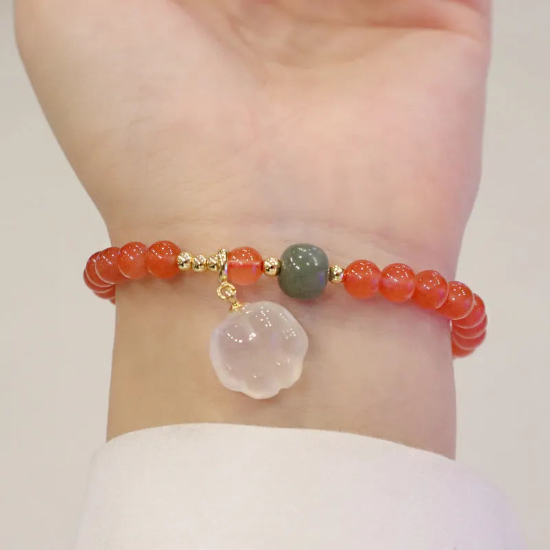Polished red agate and green jade women's bracelet with a cat's paw charm.