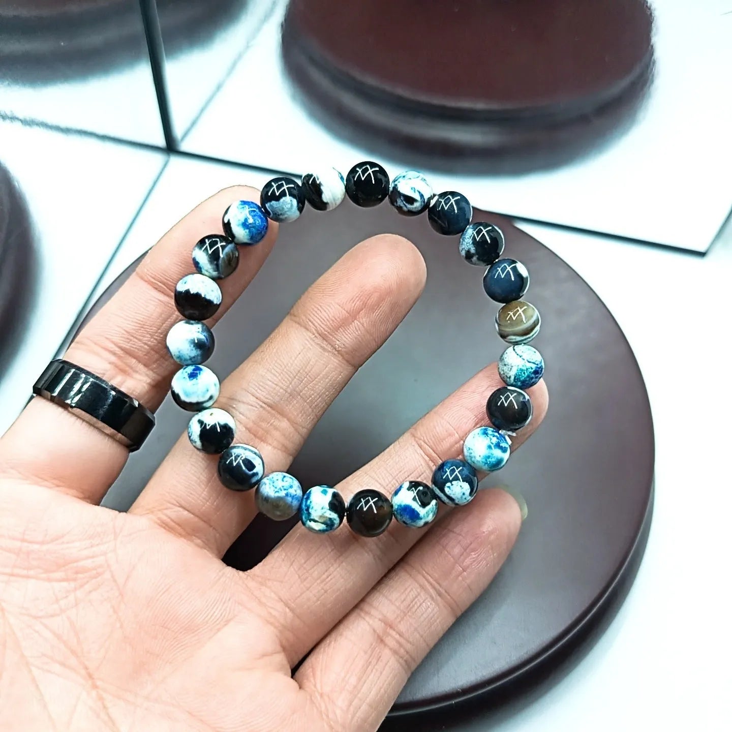 Handmade bohemian bracelet with natural agate and coloured glass beads on a wrist.