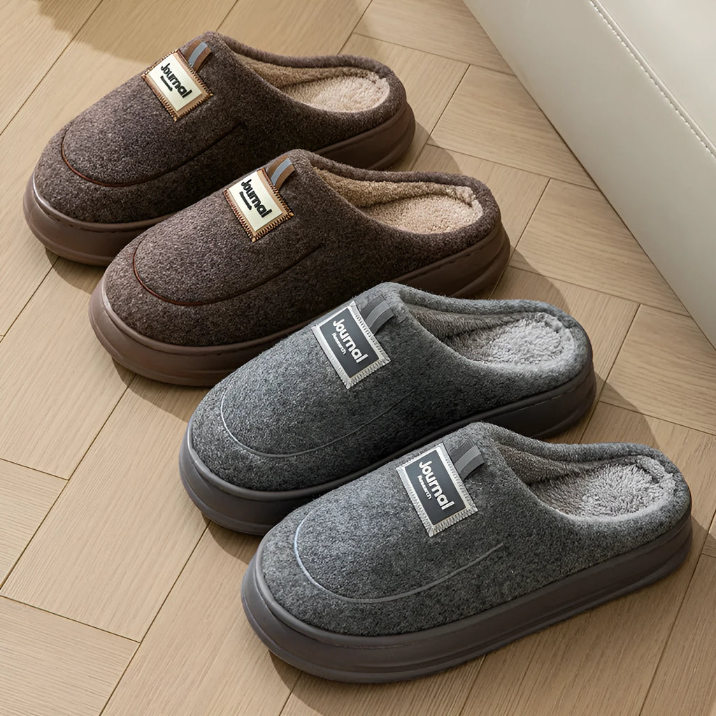 Men's brown suede slippers with a thickened design and textured EVA sole, shown on a wooden floor.