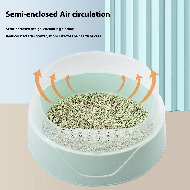 Round mint green cat litter box made from PP plastic on a wooden floor.