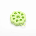 Silicone pet grooming brush with ergonomic handle shown in multiple colours: blue, green, orange, pink, purple.