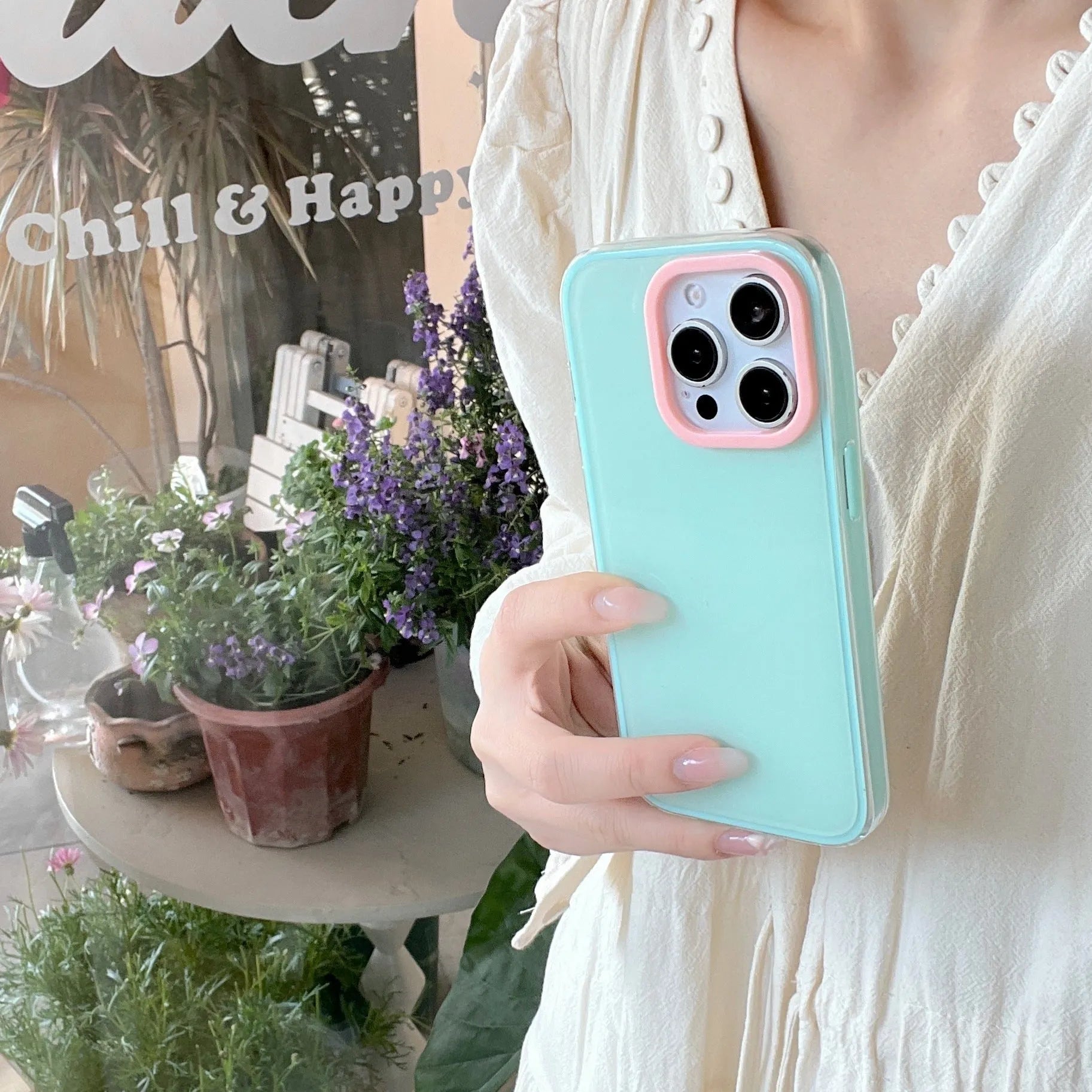 Clear jelly iPhone phone case in solid blue colour on an iPhone, showing bumper-style all-inclusive protection.